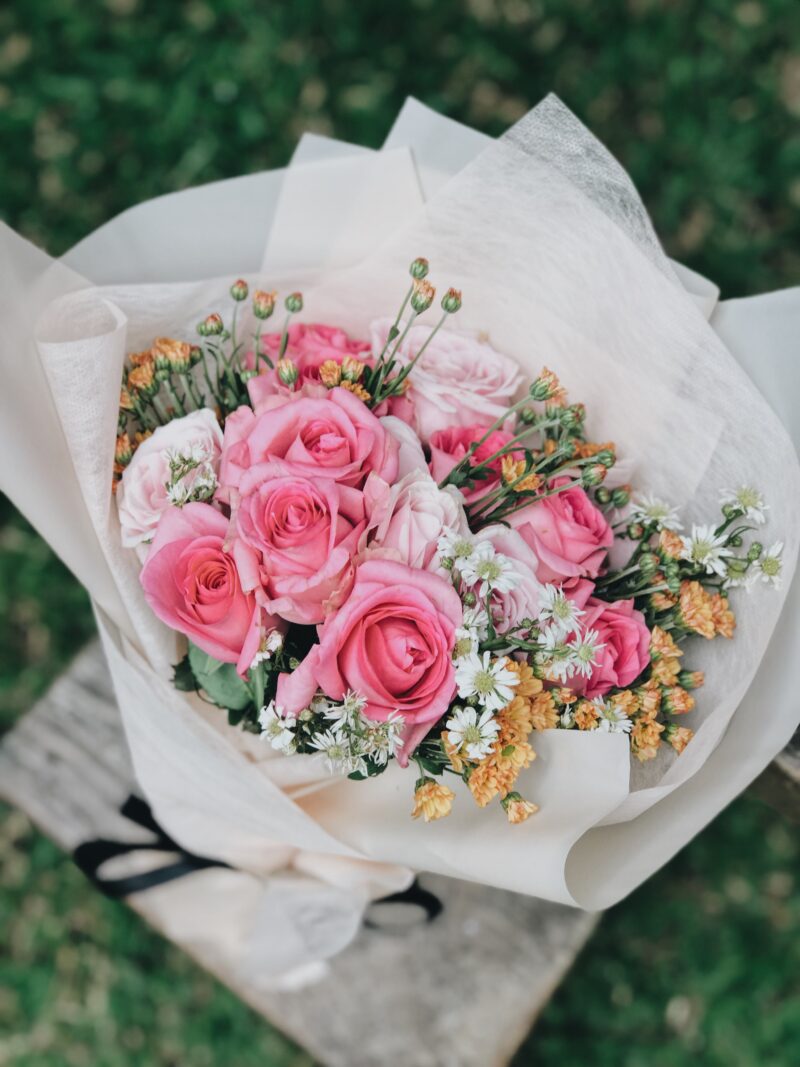 A bouquet with pink roses represents the loss of the author's friend to cancer